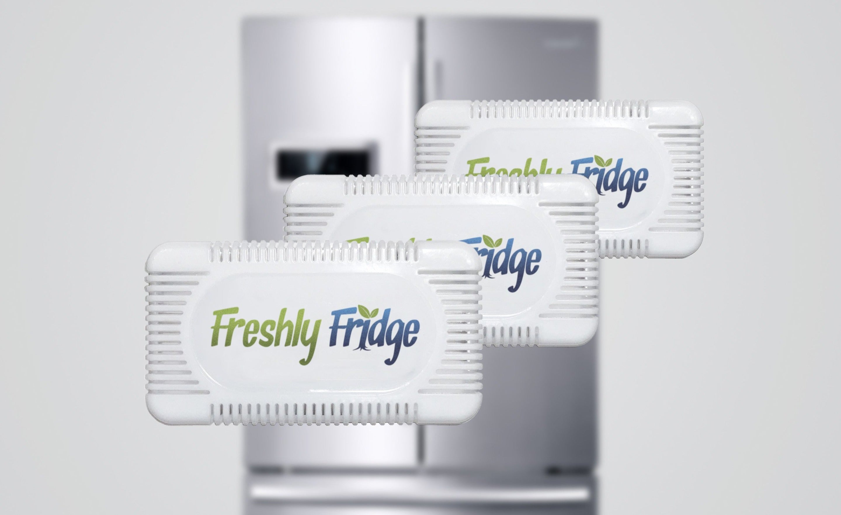 Image of three Freshly Fridge Packs with a refrigerator in the background.